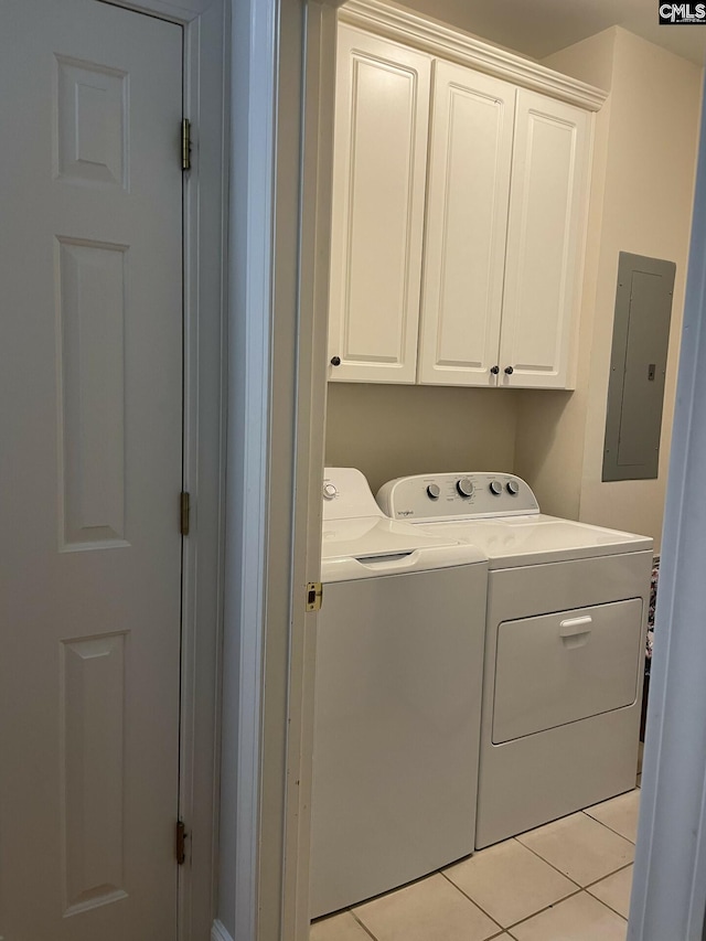 laundry area with light tile patterned floors, washing machine and dryer, electric panel, and cabinet space