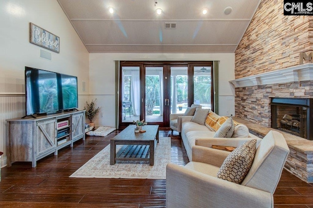 living area with high vaulted ceiling, dark wood-type flooring, a fireplace, and visible vents