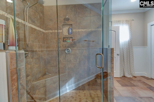 bathroom with a stall shower and crown molding