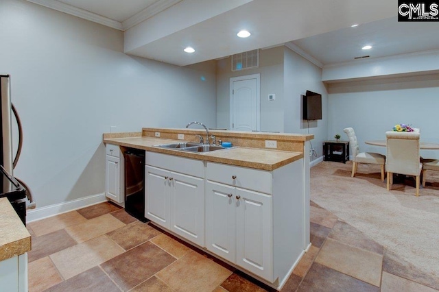 kitchen featuring visible vents, ornamental molding, light countertops, white cabinetry, and a sink