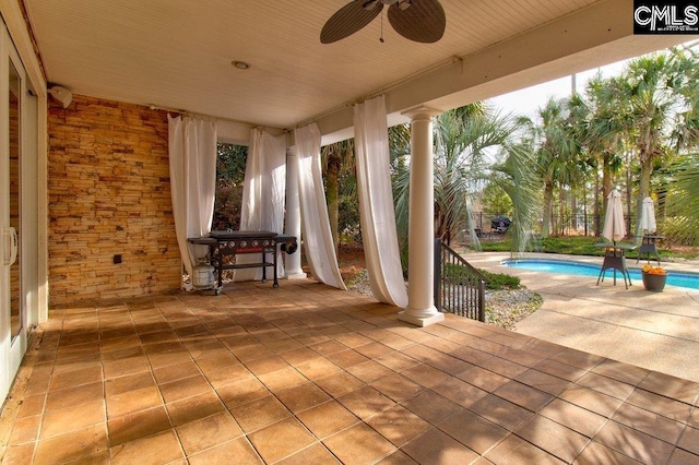 view of patio with ceiling fan and an outdoor pool