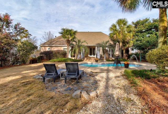 back of house featuring an outdoor pool and a patio