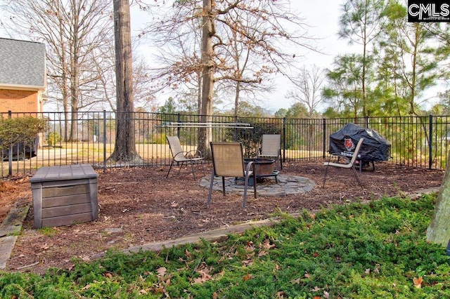 view of yard with an outdoor fire pit and fence