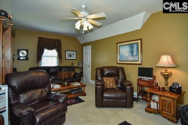 living area featuring light carpet, vaulted ceiling, and a ceiling fan