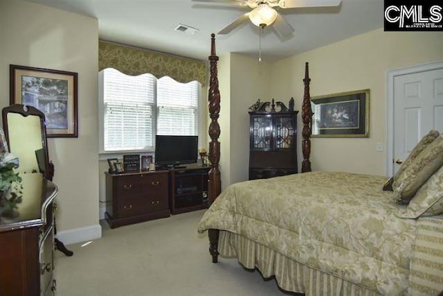 bedroom featuring light carpet, ceiling fan, visible vents, and baseboards