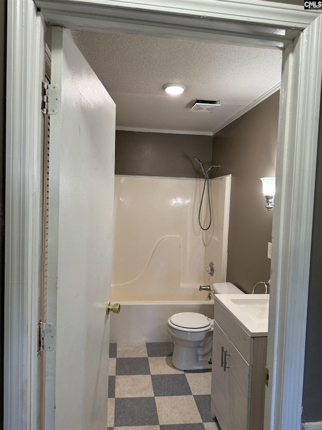 full bath featuring toilet, tile patterned floors,  shower combination, a textured ceiling, and vanity