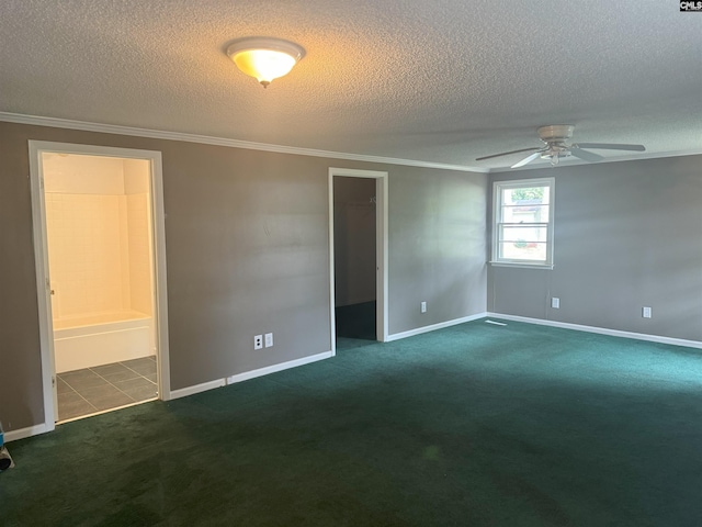 unfurnished room with baseboards, dark carpet, ceiling fan, and ornamental molding