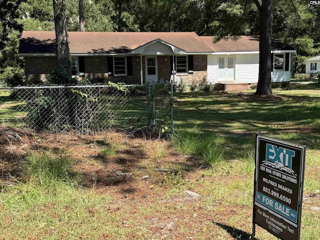 ranch-style house with a fenced front yard, a front yard, and brick siding