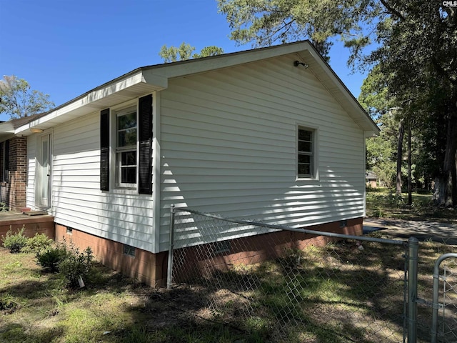 view of side of property featuring crawl space and fence