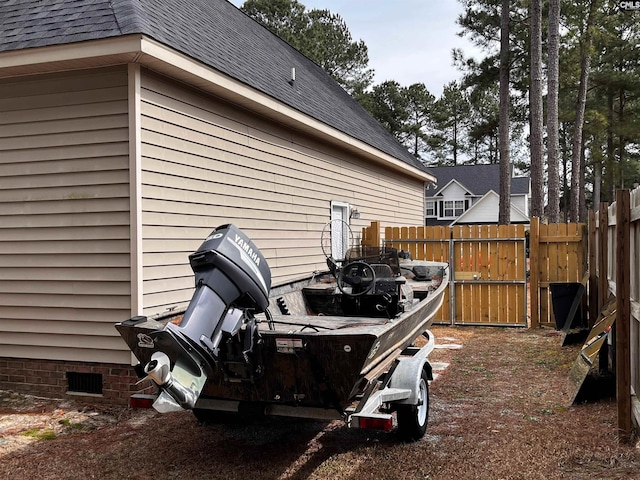 exterior space featuring a shingled roof, crawl space, and fence