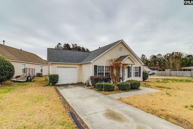 view of front of house featuring a garage, driveway, central AC, and a front yard