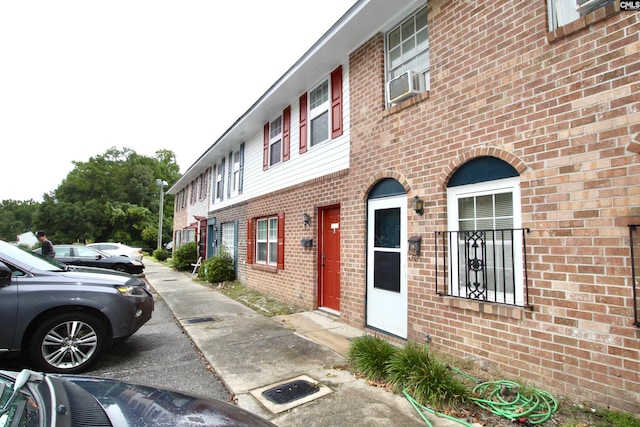 view of home's exterior featuring brick siding and cooling unit