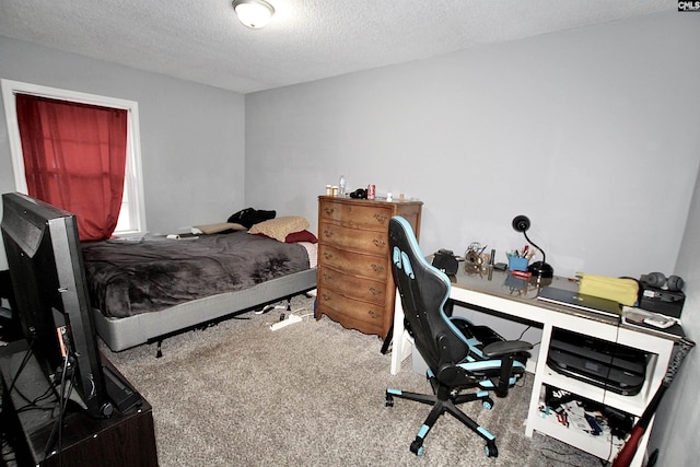 carpeted bedroom featuring a textured ceiling