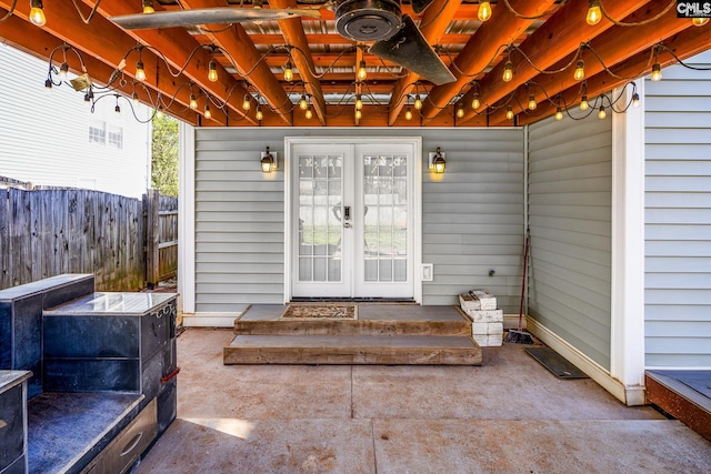 entrance to property with french doors, fence, and a patio