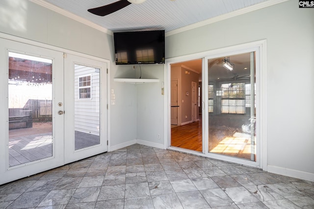 doorway featuring a ceiling fan, french doors, crown molding, and baseboards