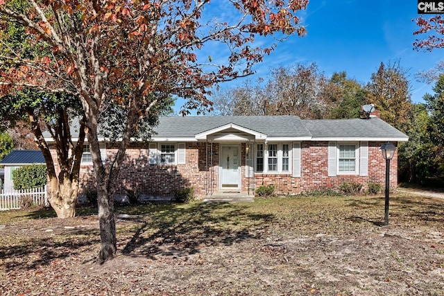 single story home with fence and brick siding