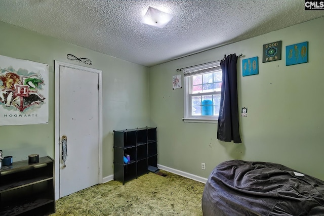 bedroom featuring a textured ceiling, carpet, visible vents, and baseboards