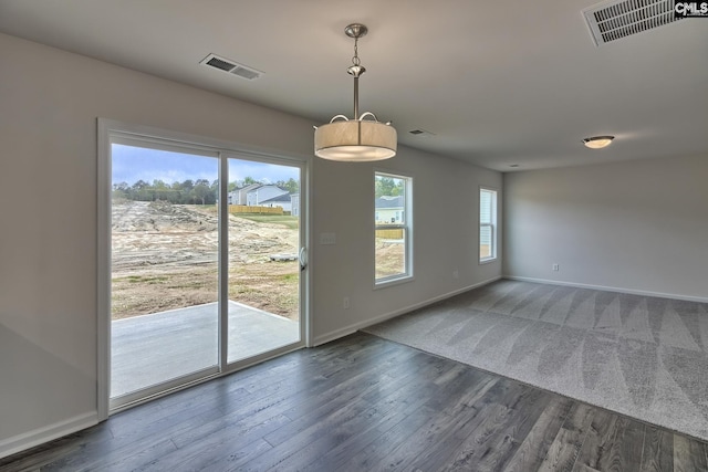 interior space with baseboards, visible vents, and dark wood-style flooring