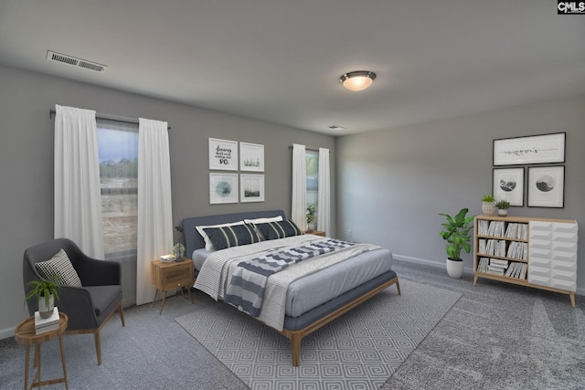 bedroom with carpet floors, multiple windows, visible vents, and baseboards