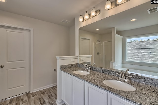 full bath featuring a sink, visible vents, and a shower stall