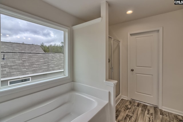 full bathroom with a garden tub, wood finished floors, a shower stall, and recessed lighting