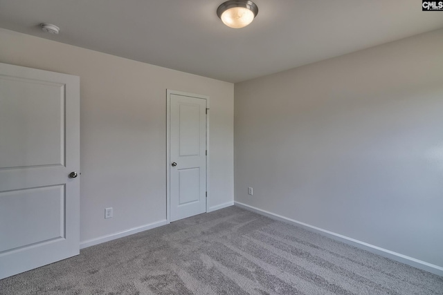 unfurnished bedroom with light carpet and baseboards