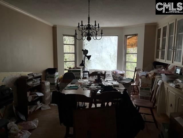 dining room with an inviting chandelier and crown molding