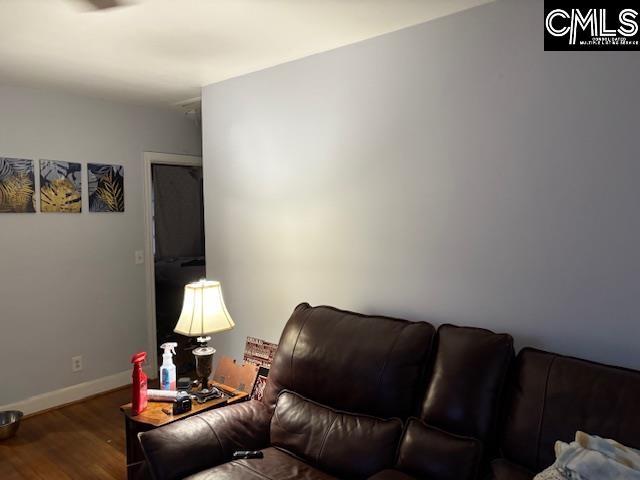 living area with wood finished floors and baseboards