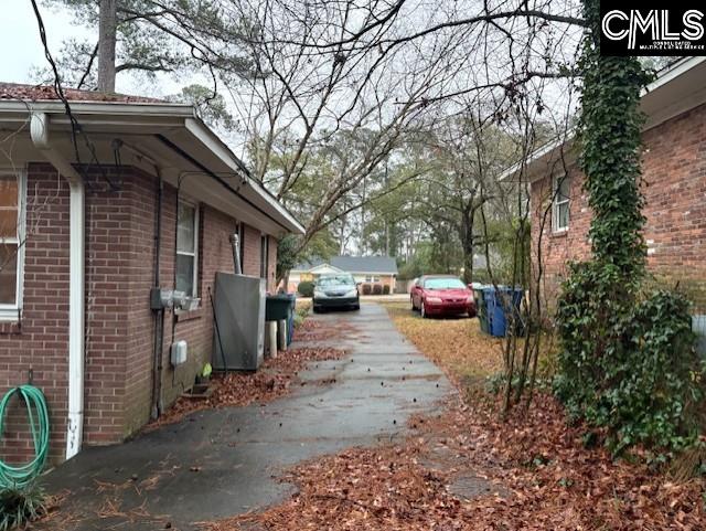 view of property exterior with brick siding