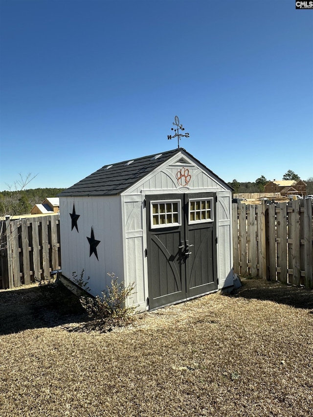 view of shed with fence