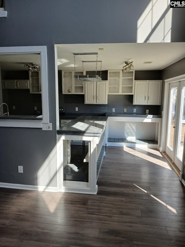 kitchen featuring dark countertops, pendant lighting, french doors, and open shelves