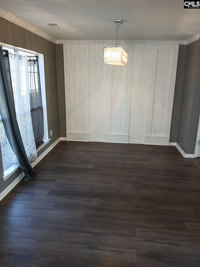 unfurnished dining area featuring baseboards, ornamental molding, and dark wood-type flooring