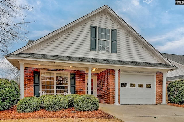 traditional-style house featuring concrete driveway, brick siding, roof with shingles, and an attached garage