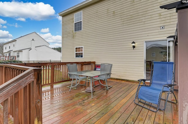 wooden deck featuring outdoor dining area