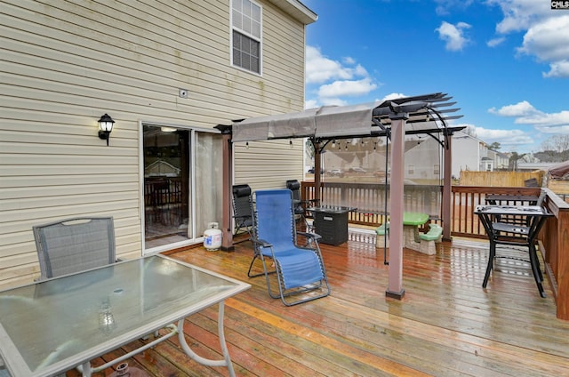 wooden deck with outdoor dining area and a pergola