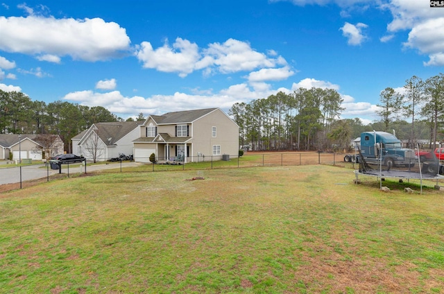 view of yard featuring a fenced backyard and a trampoline