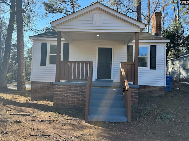 bungalow featuring crawl space and a chimney