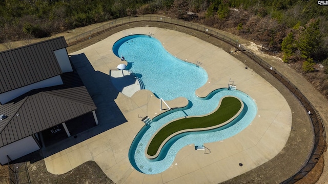 pool featuring a patio area and fence