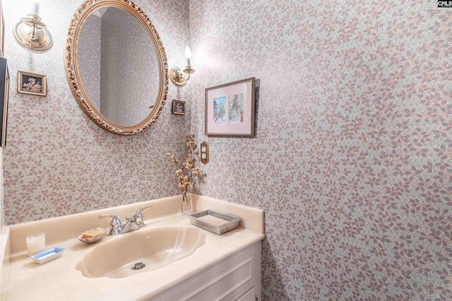 bathroom with vanity and wallpapered walls