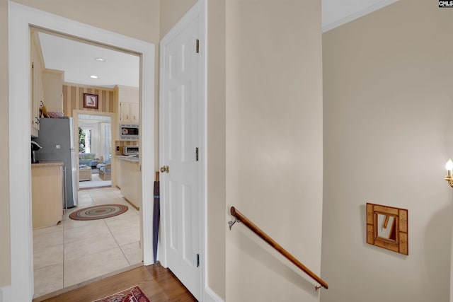 hall featuring recessed lighting, crown molding, an upstairs landing, and light tile patterned floors