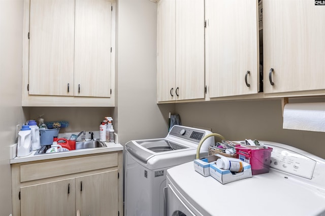 laundry area with washing machine and clothes dryer and cabinet space