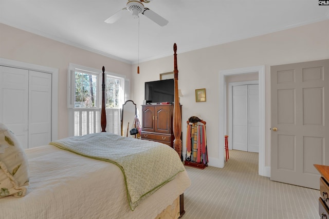 bedroom with light carpet, baseboards, a ceiling fan, crown molding, and a closet