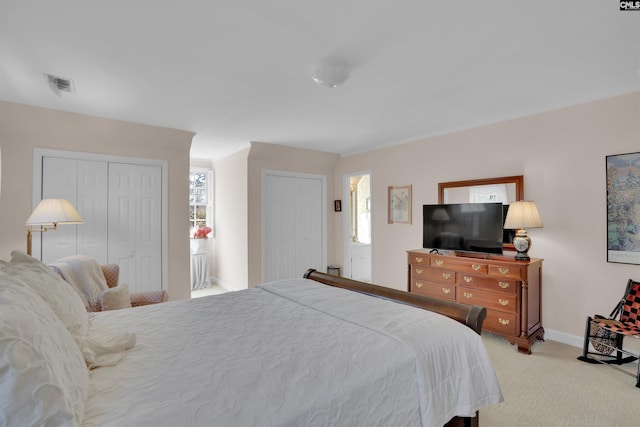 bedroom featuring light carpet, baseboards, visible vents, and a closet