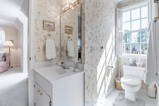 half bathroom with toilet, crown molding, vanity, and wallpapered walls