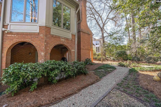 view of side of home featuring brick siding