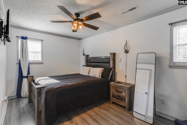 307 Wyoming Dr, Sumter, SC 29153 - bedroom with a textured ceiling, wood finished floors, visible vents, and crown molding
