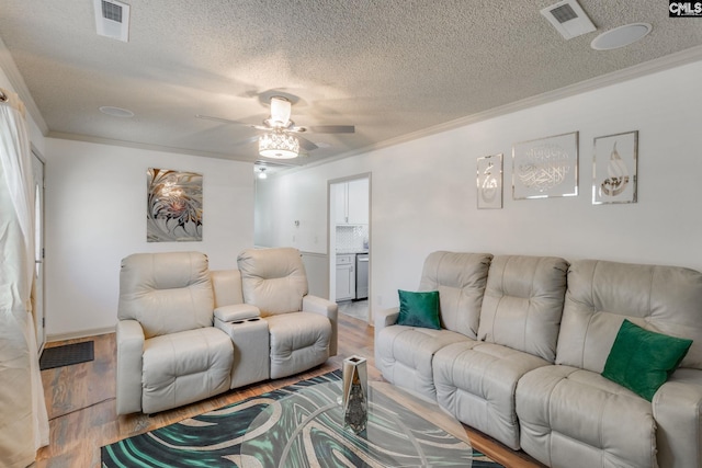 307 Wyoming Dr, Sumter, SC 29153 - living room featuring light wood-style floors, visible vents, ornamental molding, and a textured ceiling