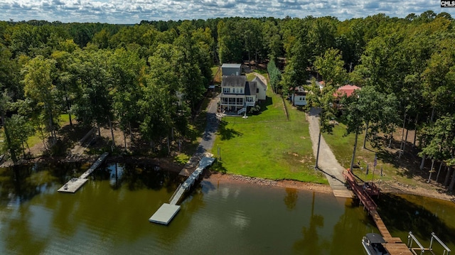 aerial view with a water view and a forest view