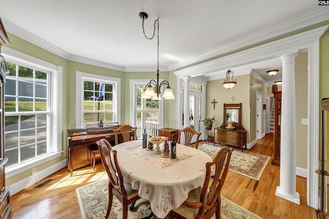 dining area with light wood-type flooring, decorative columns, visible vents, and a wealth of natural light