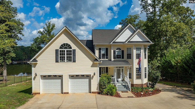 view of front of home featuring a garage, concrete driveway, and fence